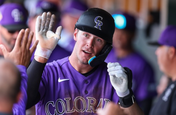 Charlie Condon #66 of the Colorado Rockies greets his teammates in the dugout after hitting a home run during the fourth inning of the spring training game against the San Francisco Giants at Scottsdale Stadium on February 26, 2026 in Scottsdale, Arizona. (Photo by Mike Christy/Getty Images)