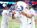 Kazuma Okamoto of the Toronto Blue Jays gets water dumped on him by Myles Straw and Vladimir Guerrero Jr. after their MLB game against the Athletics at Rogers Centre on Sunday, March 29, 2026, in Toronto. 