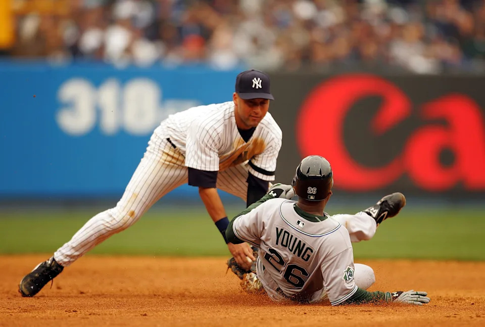 Derek Jeter of the New York Yankees tags out Delmon Young of the Tampa Bay Devil Rays.