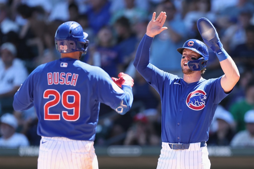 Michael Busch of the Chicago Cubs is congratulated by Nico Hoerner after hitting a two-run home run.