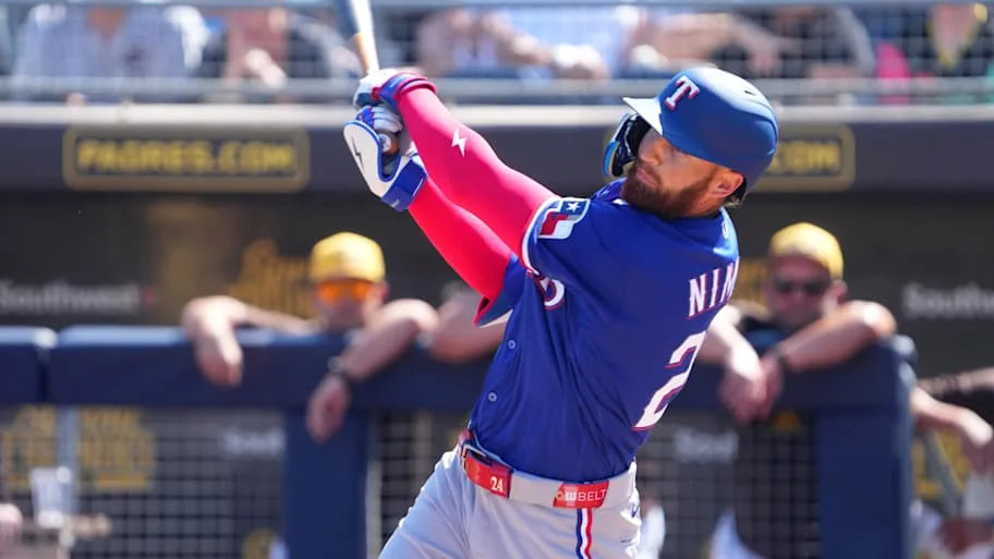 Texas Rangers left fielder Brandon Nimmo swings his bat during a game. 