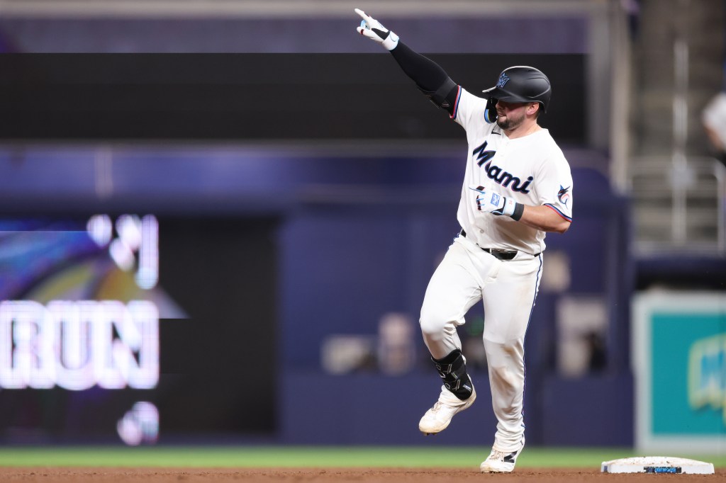 Liam Hicks of the Miami Marlins rounding the bases after hitting a two-run home run.