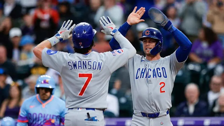 Hoerner celebrates with shortstop Dansby Swanson in the second inning against the Colorado Rockies at Coors Field.