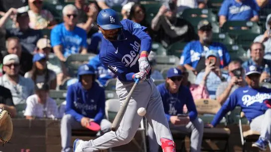 Los Angeles Dodgers shortstop Mookie Betts (50) hits against the Colorado Rockies in the third inning at Salt River Fields at Talking Stick. 