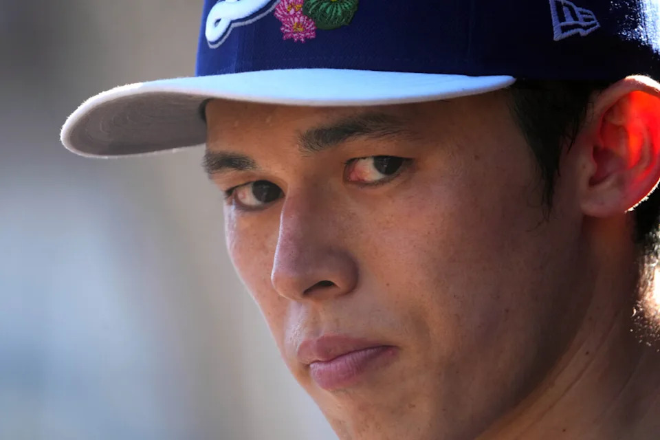 Mar 3, 2026; Goodyear, Arizona, USA; Los Angeles Dodgers starting pitcher Roki Sasaki (11) looks on against the Cleveland Guardians during the first inning at Goodyear Ballpark. Mandatory Credit: Joe Camporeale-Imagn Images