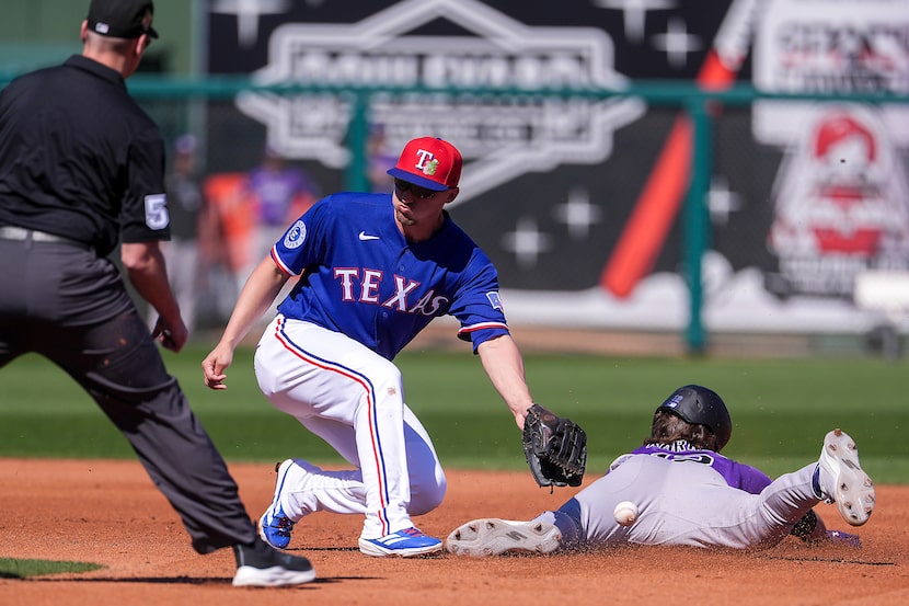 Colorado Rockies third baseman Kyle Karros (12) steals second base as the throw gets away...