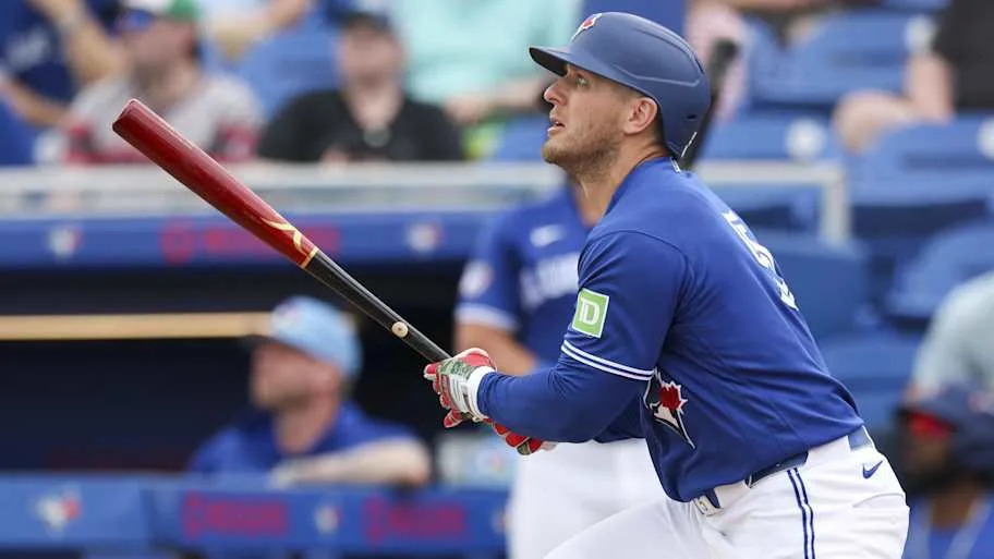 Toronto Blue Jays center fielder Daulton Varsho swings his bat at the plate.