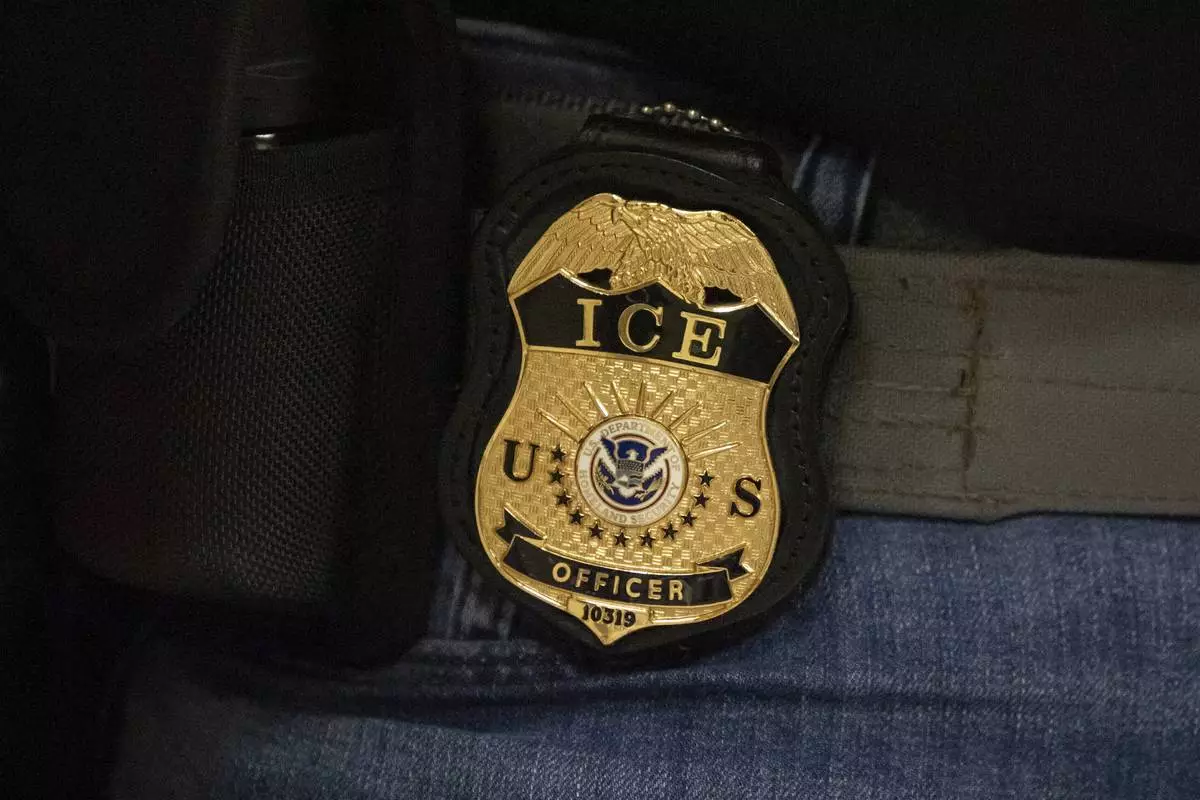 FILE - A federal agent wears an Immigration and Customs Enforcement badge in New York, June 10, 2025. (AP Photo/Yuki Iwamura, File)