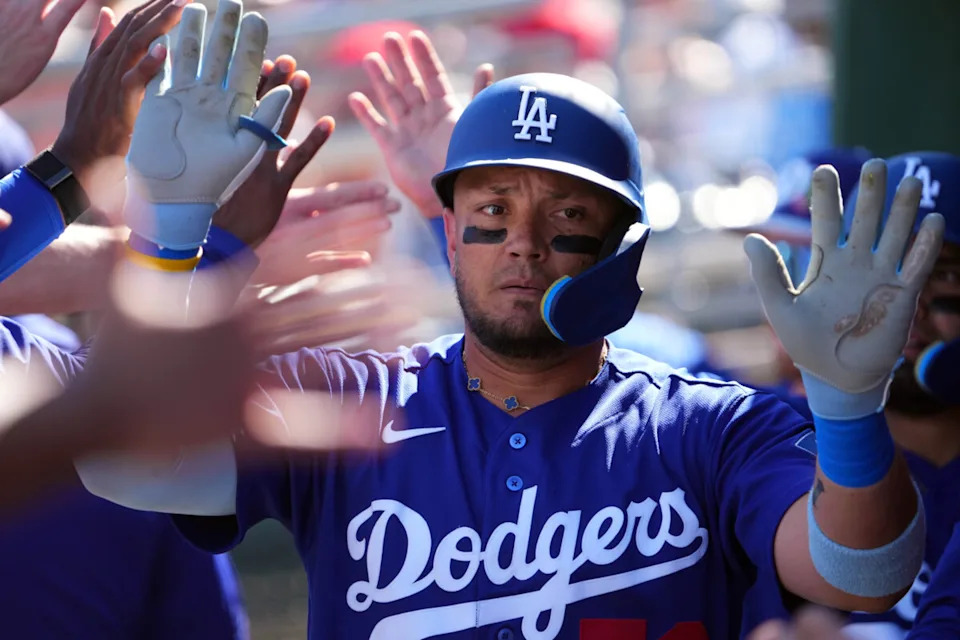 Los Angeles Dodgers designated hitter Miguel Rojas (72) high fives teammates after hitting a two run home run against the Cleveland Guardians during the third inning at Goodyear Ballpark.