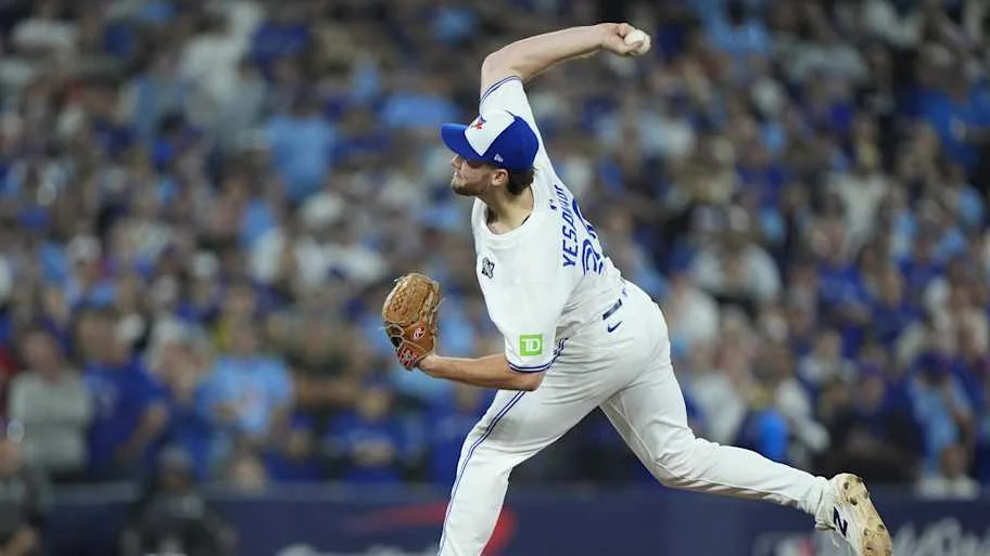 Trey Yesavage throws a baseball in a white Blue Jays uniform