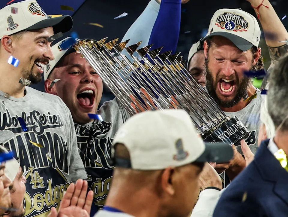 Dodgers pitcher Clayton Kershaw, right, celebrates with teammates after the Dodgers defeated the Toronto Blue Jays.