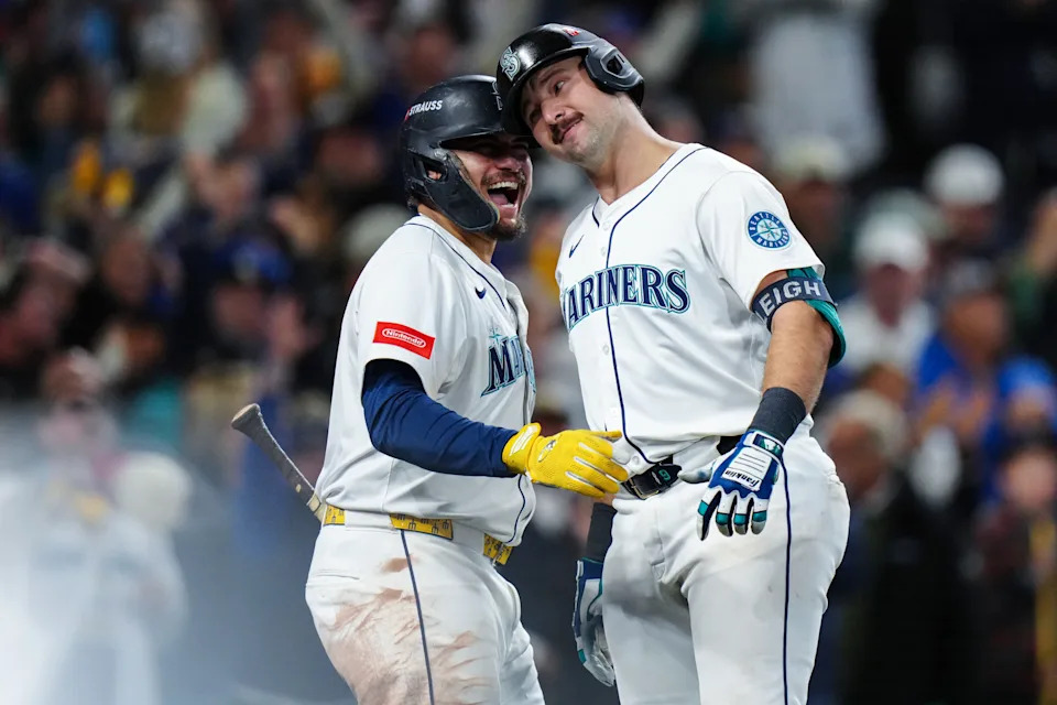 Josh Naylor and Cal Raleigh of the Seattle Mariners celebrate after Raleigh's solo home run in the fifth inning of Game Five of the American League Championship Series between the Toronto Blue Jays and the Seattle Mariners. (Photo by Daniel Shirey/MLB Photos via Getty Images)