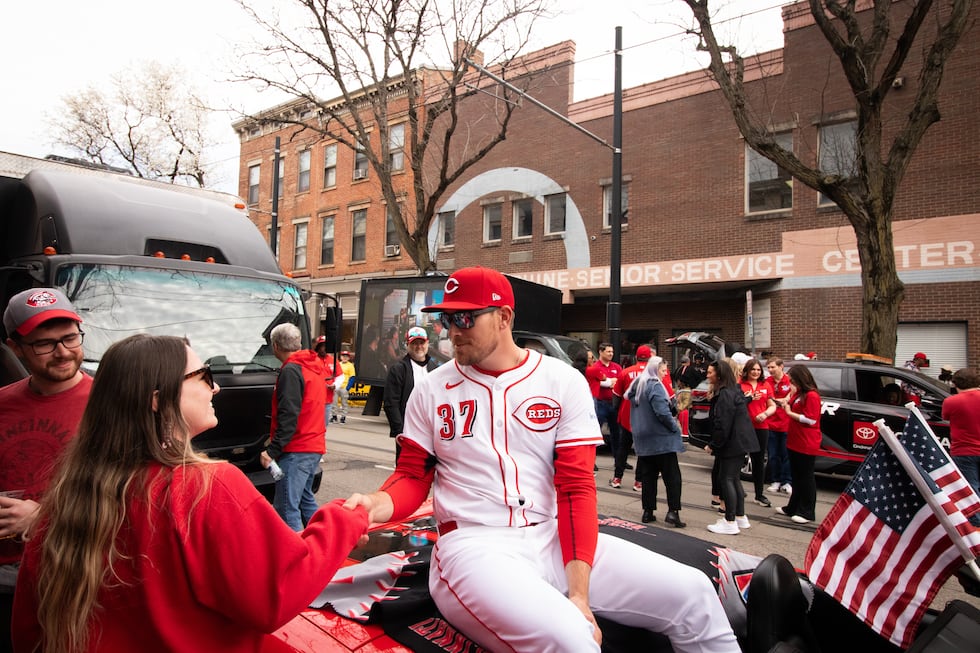 Cincinnati Reds catcher Tyler Stephenson shakes a fan's hand right before the Opening Day Parade.