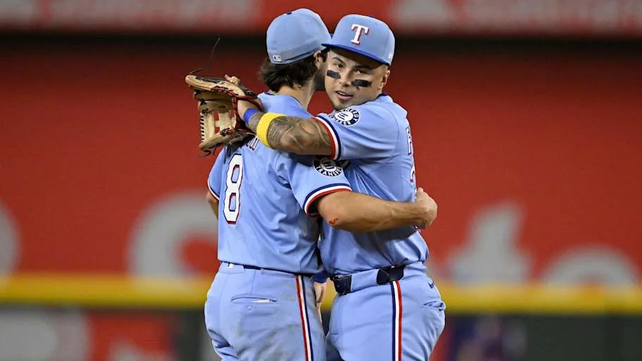 Texas Rangers shortstop Josh Smith (left) and second baseman Cody Freeman celebrate a win.