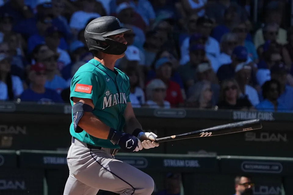 Seattle Mariners second baseman Cole Young (2) hits an RBI hit against the Chicago Cubs in the third inning at Sloan Park. Rick Scuteri-Imagn Images