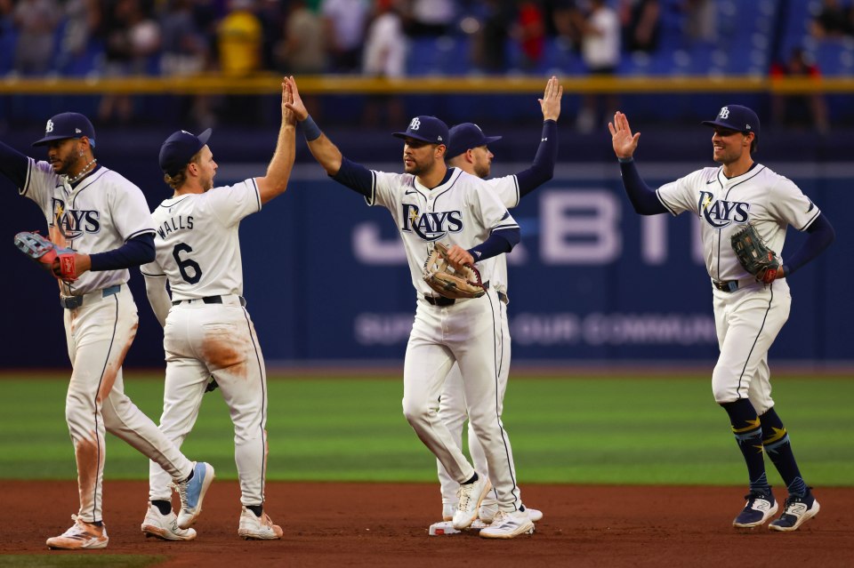 Jose Siri #22, Taylor Walls #6, Dylan Carlson #10, Brandon Lowe #8 and Josh Lowe #15 of the Tampa Bay Rays celebrate a win
