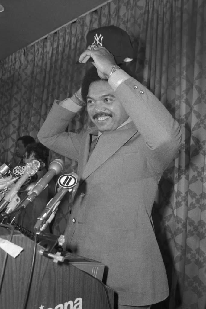 Slugging outfielder Reggie Jackson tries on his new Yankee hat after signing a five-year, estimated $3 million contract with the New York Yankees here November 29th. Bettmann Archive