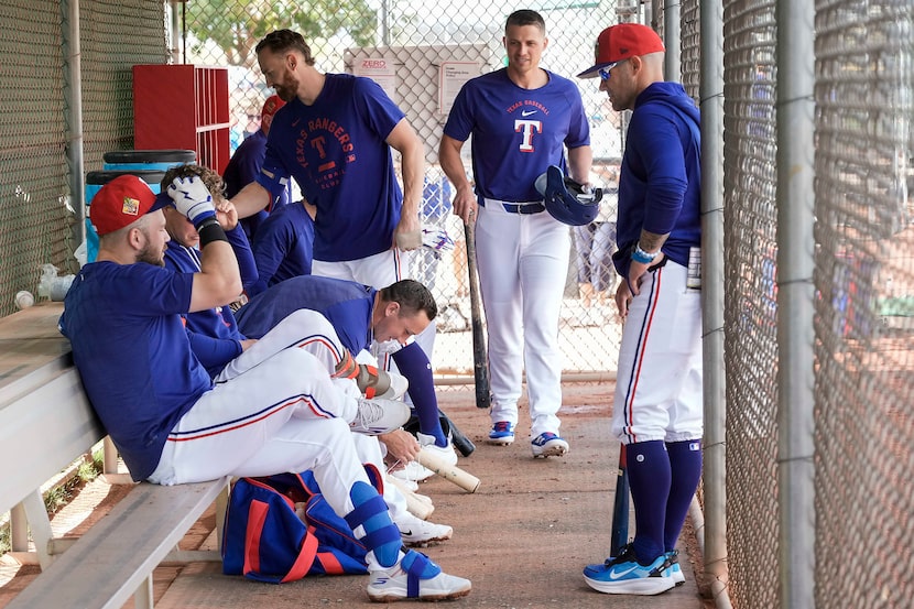 Texas Rangers manager Skip Schumaker (right) talks with players, from left, Jake Burger, Joc...