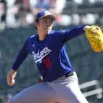 Los Angeles Dodgers starting pitcher Roki Sasaki (11) pitches against the Cleveland Guardians during the first inning at Goodyear Ballpark.