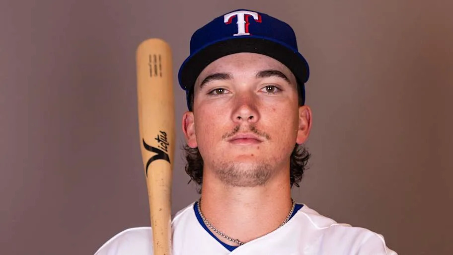 Texas Rangers infielder Cameron Cauley poses with a bat on his shoulder during a photo shoot