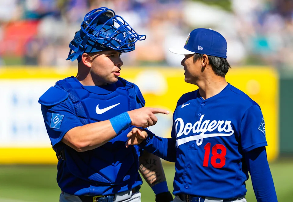 Feb 21, 2026; Tempe, Arizona, USA; Los Angeles Dodgers catcher Dalton Rushing (left) talks with pitcher Yoshinobu Yamamoto against the Los Angeles Angels during a spring training game at Tempe Diablo Stadium. Mandatory Credit: Mark J. Rebilas-Imagn Images