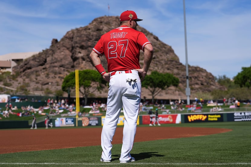 Los Angeles Angels' Mike Trout pauses as he warms up prior to a spring training baseball...
