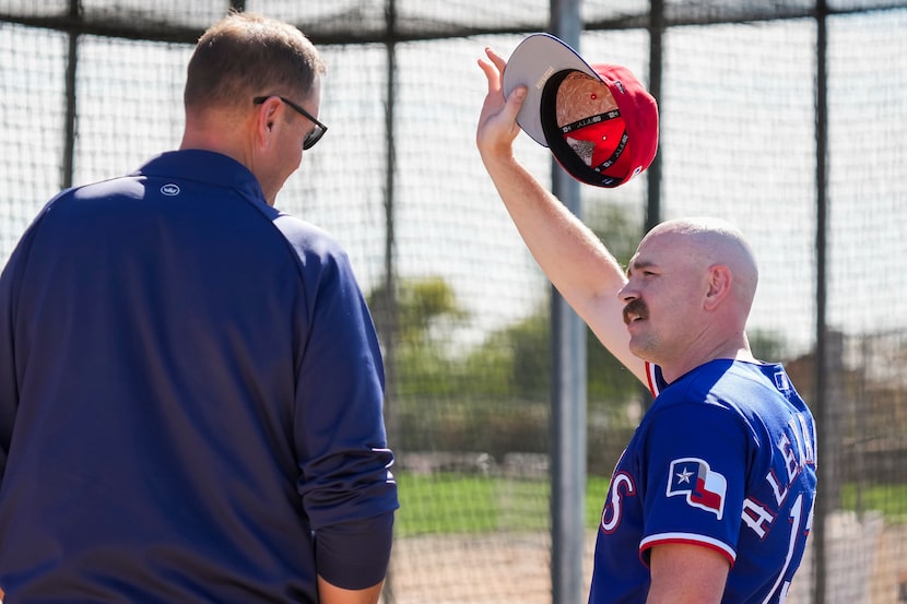 Texas Rangers pitcher Tyler Alexander talks with president of baseball operations Chris...