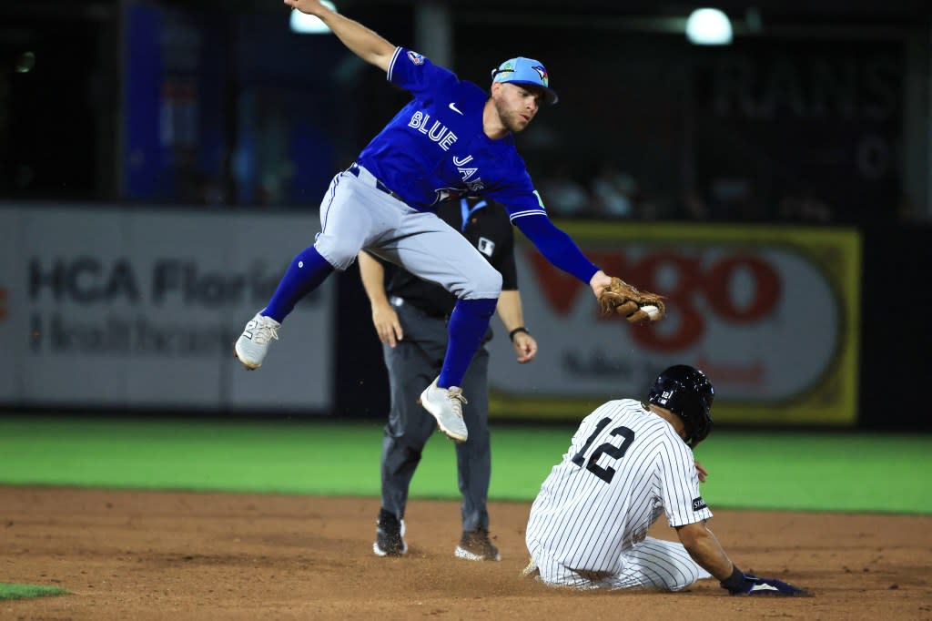 Toronto Blue Jays infielder Rafael Lantigua (72) attempted to tag out New York Yankees center fielder Trent Grisham (12) as he stole second base during the fifth inning at George M. Steinbrenner Field. IMAGN IMAGES via Reuters Connect