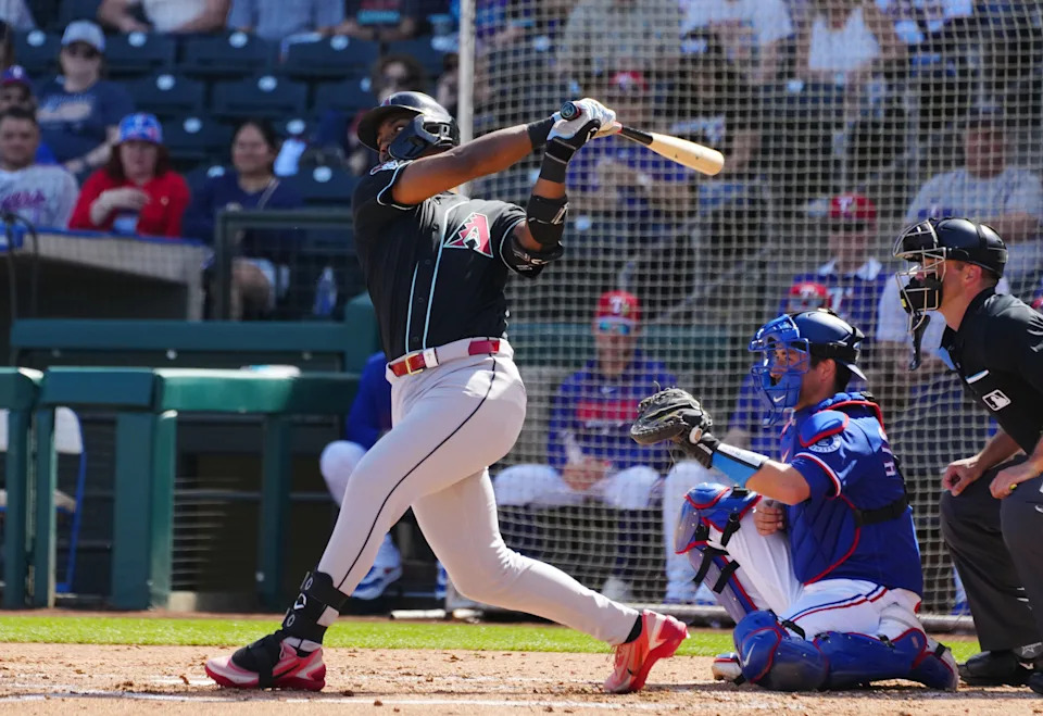 Diamondbacks infielder LuJames Groover (91) hits a double against the Rangers during a spring training game in Surprise on Feb. 24, 2026.