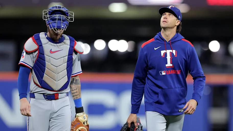 Texas Rangers catcher Jonah Heim (28) and starting pitcher Jacob deGrom (48) walk in from the bullpen.