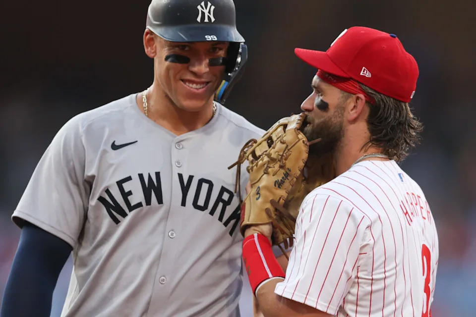 Jul 30, 2024; Philadelphia, Pennsylvania, USA; New York Yankees outfielder Aaron Judge (99) with Philadelphia Phillies first base Bryce Harper (3) on first base after his single during the first inning at Citizens Bank Park. Mandatory Credit: Bill Streicher-USA TODAY Sports