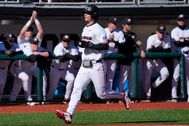 GeorgiaÕs Christian Adams (5) runs into home to score during an NCAA baseball game against UIC in Athens, Ga., on Friday, Feb. 21, 2025.