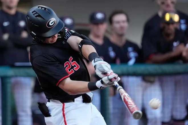 Georgia catcher Daniel Jackson (25) hits the ball during a NCAA baseball game against Arkansas in Athens, Ga., on Friday, April 11, 2025.