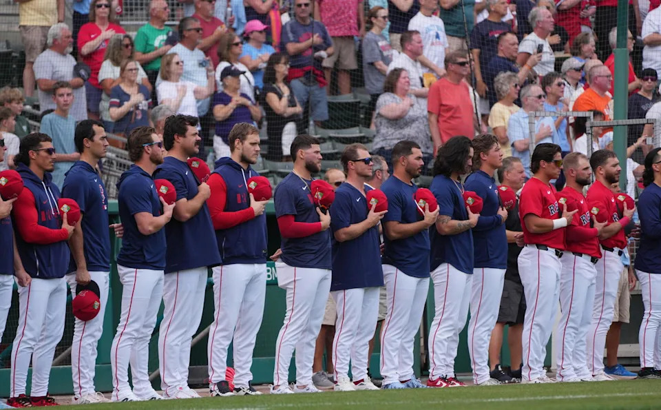 Feb 26, 2026; Fort Myers, Florida, USA; Boston Red Sox players stand on the field during the national anthem before the game against the Tampa Bay Rays at JetBlue Park at Fenway South. (Jim Rassol/Imagn Images)