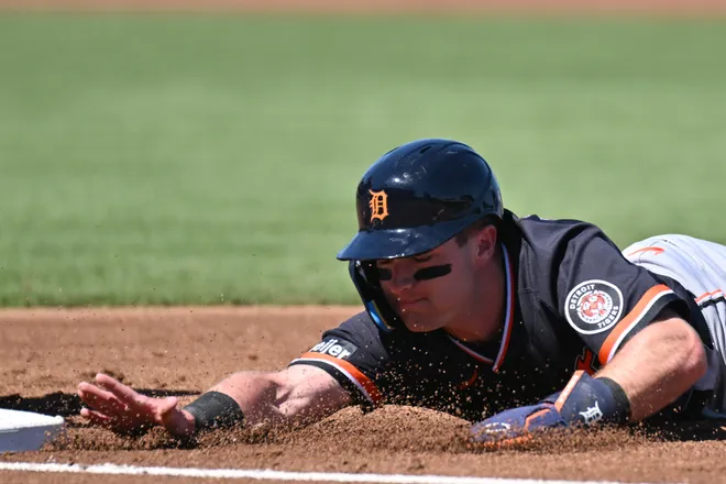 Detroit Tigers shortstop Kevin McGonigle (85) dives back to first base in the first inning against the Atlanta Braves during spring training at CoolToday Park in North Port, Florida, on Tuesday, Feb. 24, 2026.