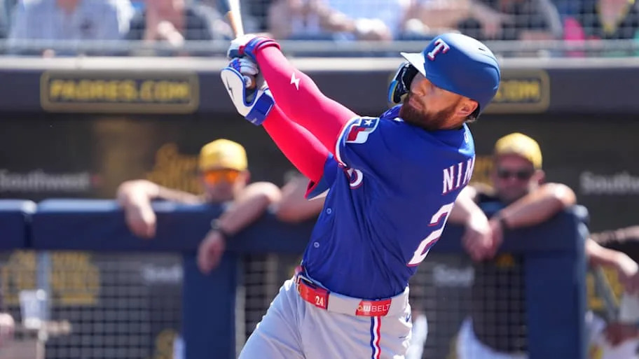 Texas Rangers left fielder Brandon Nimmo swings a bat.