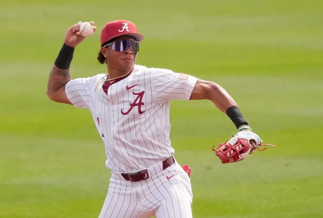 Feb 14, 2026; Tuscaloosa, AL, USA; Alabama shortstop Justin Lebron (1) fields a ground ball and throws to first for an out as the Crimson Tide played Washington State at Sewell-Thomas Stadium. Alabama played a double header against Washington State Saturday to escape Sunday’s forecast rain.
