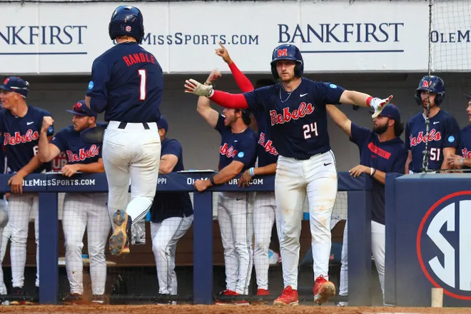 Jun 2, 2025; Oxford, MS, USA; Mississippi Rebels catcher Austin Fawley (24) reacts with shortstop Brayden Randle (1), after Randle scored during the seventh inning against the Murray State Racers. Mandatory Credit: Petre Thomas-Imagn Images