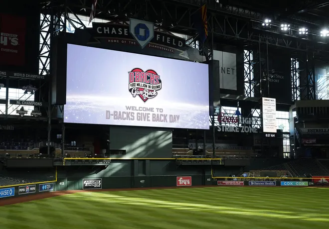 Arizona Diamondbacks celebrate the $100 million raised by the D-backs Give Back charity donations during an event at Chase Field on March 9, 2026, in Phoenix.