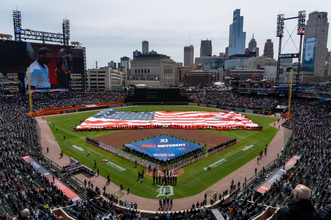 Hundreds of fans stand for the Pledge of Allegiance before the start of the Detroit Tigers' Opening Day game against the Chicago White Sox at Comerica Park.