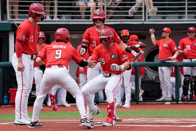 Georgia catcher Daniel Jackson (25) celebrates with Georgia infielder Kolby Branch (9) after hitting a home run