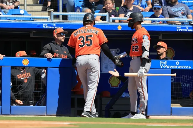 Mar 18, 2026; Dunedin, Florida, USA; Baltimore Orioles catcher Adley Rutschman (35) is congratulated after he scored a run during the first inning against the Baltimore Orioles at TD Ballpark.