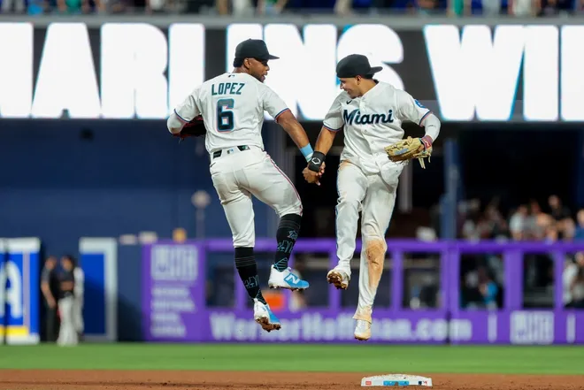 Mar 27, 2026; Miami, Florida, USA; Miami Marlins second baseman Otto Lopez (6) and third baseman Javier Sanoja (8) celebrate after the game against the Colorado Rockies at loanDepot Park.