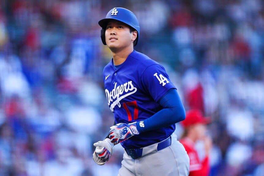 Shohei Ohtani of the Los Angeles Dodgers jogs back to the dugout during the first inning of a MLB spring training game against the Los Angeles Angels.