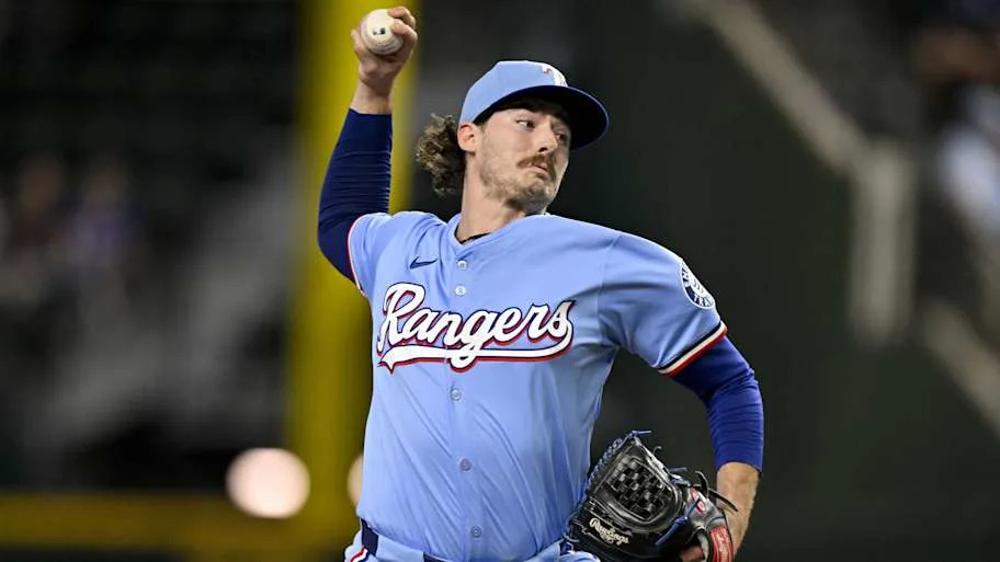 Texas Rangers relief pitcher Cole Winn throws a baseball during a game. 