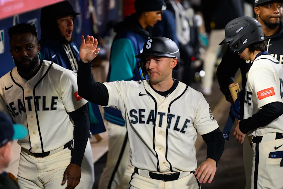 Mar 29, 2026; Seattle, Washington, USA; Seattle Mariners designated hitter Dominic Canzone (8) celebrates in the dugout after scoring a run against the Cleveland Guardians during the fourth inning.