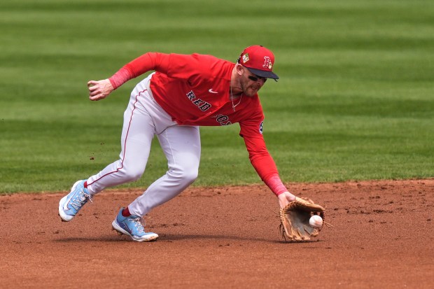Boston Red Sox shortstop Trevor Story fields an infield grounder to turn a double play off Tampa Bay Rays' Edward Olivares to end the first inning of a spring training baseball game in Fort Myers, Fla., Thursday, Feb. 26, 2026. (AP Photo/Gerald Herbert)
