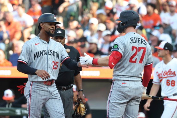 Byron Buxton and Ryan Jeffers slap hands