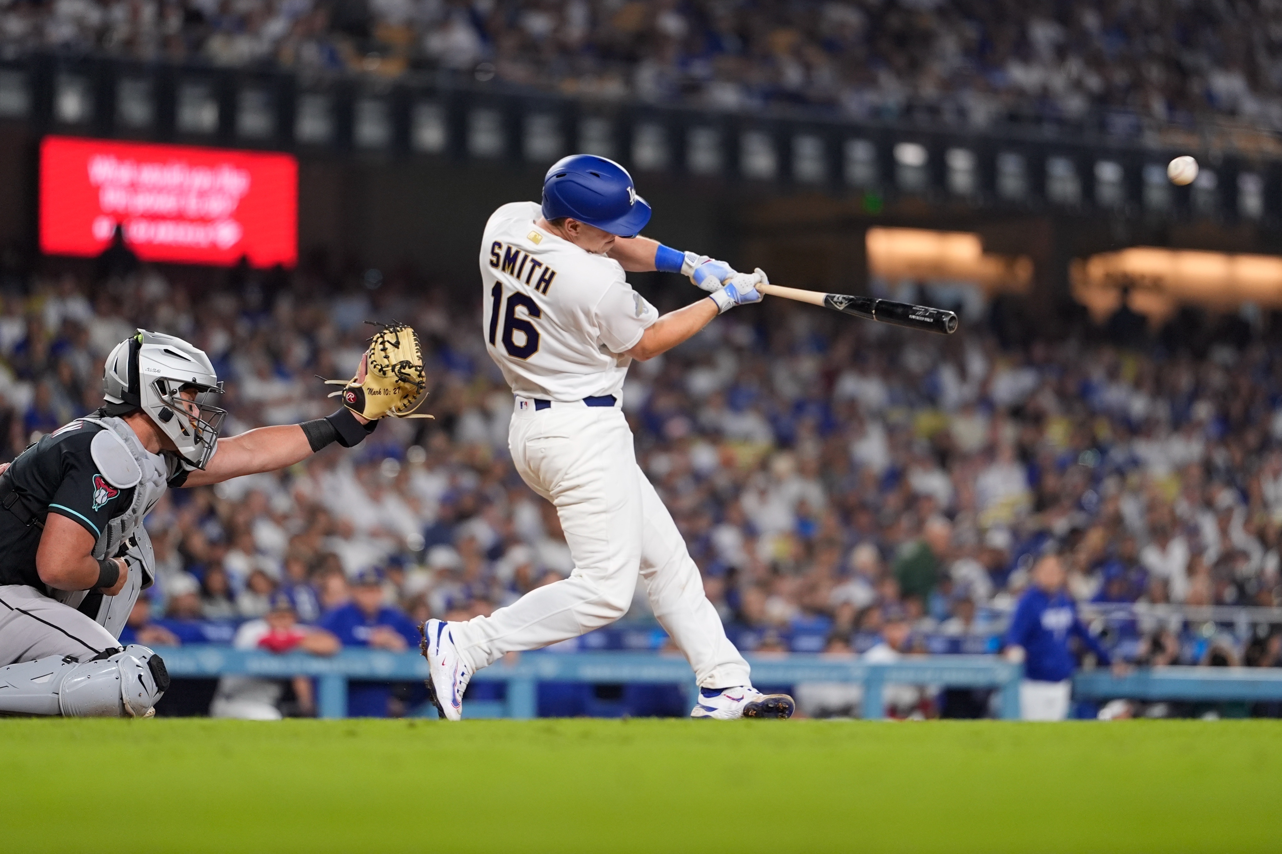 Dodgers’ Will Smith, right, hits a two-run home run as...