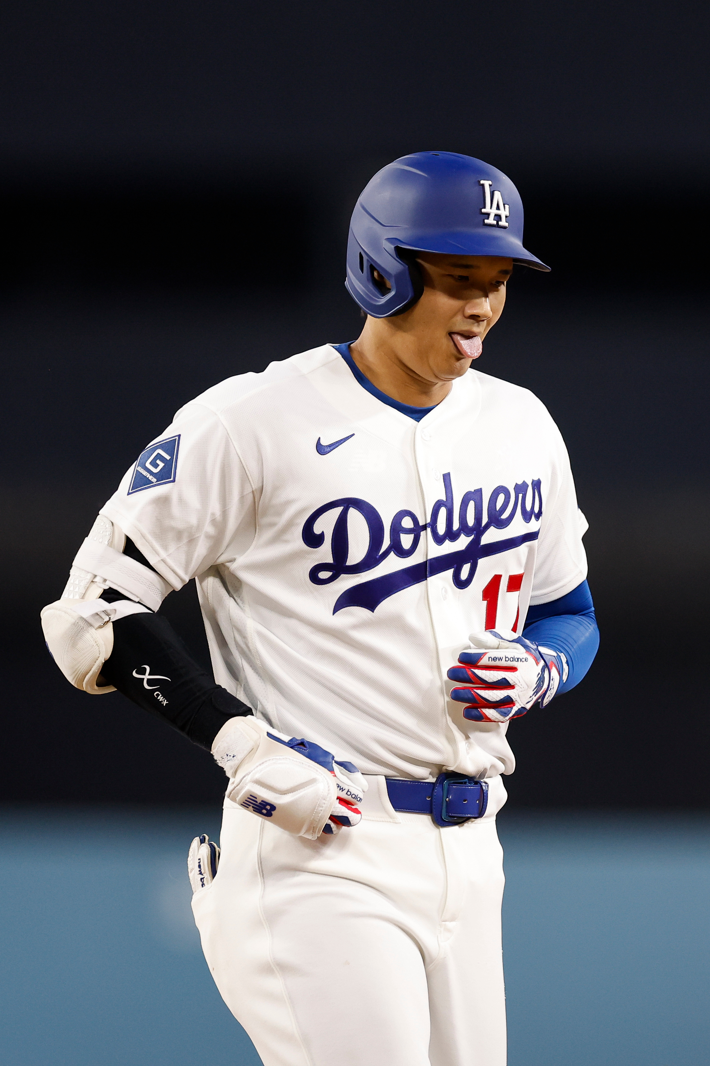 Dodgers star Shohei Ohtani reacts after hitting a single during...
